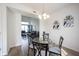 Bright dining area features a glass table and seating for four; open concept at 895 Geronimo Dr, Greenfield, IN 46140