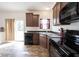 Bright eat-in kitchen offers warm wood cabinets and sliding glass doors to the backyard at 895 Geronimo Dr, Greenfield, IN 46140
