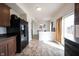 Kitchen showcases open floor plan leading into dining area, dark appliances and tile floor at 895 Geronimo Dr, Greenfield, IN 46140