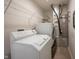 Laundry room equipped with modern appliances, white shelving and a hot water heater at 895 Geronimo Dr, Greenfield, IN 46140