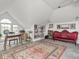 Finished attic space with art collection and seating area, boho rug, and light gray carpet at 914 N College Ave, Indianapolis, IN 46202