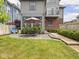 Backyard featuring a wooden patio with an umbrella table set and a lush lawn at 914 N College Ave, Indianapolis, IN 46202
