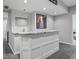 Contemporary basement wet bar features granite countertops, cabinetry, and a stylish mirror, ideal for entertaining guests at 914 N College Ave, Indianapolis, IN 46202