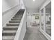 View of the basement featuring carpeted stairs and a glimpse into a comfortable living area at 914 N College Ave, Indianapolis, IN 46202
