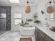 Beautiful bathroom featuring a soaking tub, modern lighting, and stylish decor at 914 N College Ave, Indianapolis, IN 46202