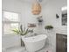 Bright bathroom with tub, vanity, and modern lighting at 914 N College Ave, Indianapolis, IN 46202