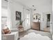 This room features a comfy armchair, a stylish dresser, and abundant natural light at 914 N College Ave, Indianapolis, IN 46202