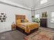 This inviting bedroom features a statement headboard, plants, natural light, and a cozy area rug at 914 N College Ave, Indianapolis, IN 46202