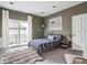 Bedroom features a cozy bed, sliding glass doors to a balcony, and tasteful decor at 914 N College Ave, Indianapolis, IN 46202