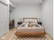 Well-lit bedroom with stylish decor, including a wooden bed frame, patterned rug, and a functional desk area at 914 N College Ave, Indianapolis, IN 46202