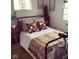 Well decorated bedroom featuring natural light, patterned pillows, and rustic decor at 914 N College Ave, Indianapolis, IN 46202