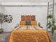 This bedroom features a beautiful headboard, plants, and natural light at 914 N College Ave, Indianapolis, IN 46202
