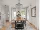 Bright dining room with large wooden table, crystal chandelier and lots of natural light at 914 N College Ave, Indianapolis, IN 46202