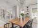 Open dining room featuring a wooden table with seating for six, a crystal chandelier and access to other rooms at 914 N College Ave, Indianapolis, IN 46202