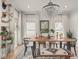 Inviting dining room with natural light, unique decor and a wooden table with seating for six at 914 N College Ave, Indianapolis, IN 46202