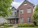 Charming brick home featuring a covered front porch, manicured landscaping, and inviting curb appeal at 914 N College Ave, Indianapolis, IN 46202