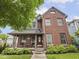Charming red brick home with well-manicured landscaping and wrought iron fence at 914 N College Ave, Indianapolis, IN 46202