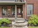 Inviting front porch with seating and stylish brickwork at 914 N College Ave, Indianapolis, IN 46202