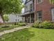 Charming home with covered front porch, lush lawn, manicured landscaping, and inviting curb appeal at 914 N College Ave, Indianapolis, IN 46202