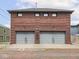 Exterior view of brick three car garage with gray doors at 914 N College Ave, Indianapolis, IN 46202