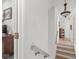 Hallway showing hardwood stairs and flooring, with a view of a study or library at 914 N College Ave, Indianapolis, IN 46202