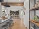Bright kitchen features sleek countertops, white cabinets, hardwood floors, and a decorative hutch at 914 N College Ave, Indianapolis, IN 46202