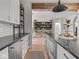 Modern kitchen with black countertops, stainless appliances, gray cabinets, and wood floors at 914 N College Ave, Indianapolis, IN 46202
