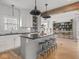 Charming kitchen boasts white cabinetry, black countertops, subway tile backsplash, and large island with seating at 914 N College Ave, Indianapolis, IN 46202
