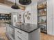 Stylish kitchen with gray island, stainless steel appliances, white cabinets, and wood beam at 914 N College Ave, Indianapolis, IN 46202