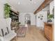 Open living area featuring wood floors, accent beams, and a stylish display cabinet at 914 N College Ave, Indianapolis, IN 46202
