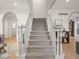 Elegant staircase featuring carpeted steps and white banisters at 914 N College Ave, Indianapolis, IN 46202