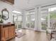 Sunroom boasts large windows overlooking a serene backyard, complemented by a stylish cabinet at 914 N College Ave, Indianapolis, IN 46202