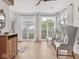 Bright sunroom featuring natural light, white curtains, and comfortable seating at 914 N College Ave, Indianapolis, IN 46202