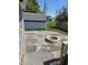 Backyard area with a stone paver patio and outdoor fire pit at 951 N Maiellen Dr, Greenfield, IN 46140