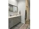 Ensuite bathroom featuring a double vanity with gray cabinets and a large framed mirror at 951 N Maiellen Dr, Greenfield, IN 46140