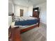 Spacious primary bedroom features neutral carpet, a ceiling fan, and view to the ensuite bathroom at 951 N Maiellen Dr, Greenfield, IN 46140