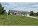 Charming brick home featuring an attached two-car garage and a well-manicured lawn at 951 N Maiellen Dr, Greenfield, IN 46140