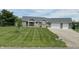 Attractive brick home with a two-car garage, paved driveway, and a meticulously striped lawn at 951 N Maiellen Dr, Greenfield, IN 46140