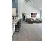 Open-concept living area with high ceilings, an American flag, and counter seating for the kitchen at 951 N Maiellen Dr, Greenfield, IN 46140