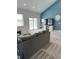 Open living room features a vaulted ceiling, recessed lighting, and sliding glass door to the backyard at 951 N Maiellen Dr, Greenfield, IN 46140