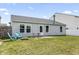 Spacious backyard featuring lush grass, a fire pit with Adirondack chairs, and a patio at 9560 W Campfire Dr, Pendleton, IN 46064