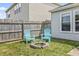 Cozy backyard fire pit area with Adirondack chairs next to a wooden fence at 9560 W Campfire Dr, Pendleton, IN 46064