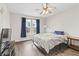 Well-lit bedroom with a ceiling fan, wood-look floors, and a picturesque window view at 9560 W Campfire Dr, Pendleton, IN 46064