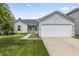 Charming single-story home with a two-car garage, well-maintained lawn, and welcoming curb appeal at 9560 W Campfire Dr, Pendleton, IN 46064