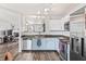 Bright kitchen with stainless steel appliances, two-tone cabinets and wood floors at 9560 W Campfire Dr, Pendleton, IN 46064