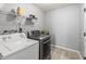 Functional laundry room featuring a washer, dryer, and storage shelf at 9560 W Campfire Dr, Pendleton, IN 46064