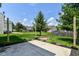 A well maintained backyard with healthy green grass, a firepit, and lush landscaping at 9676 W Constellation Dr, Pendleton, IN 46064