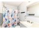 Bright bathroom with a decorative ocean themed shower curtain and gray cabinets at 9676 W Constellation Dr, Pendleton, IN 46064
