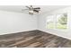 Neutral bedroom with wood-look floors, ceiling fan, and large windows offering plenty of natural light at 9676 W Constellation Dr, Pendleton, IN 46064