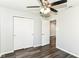 This bedroom features wood-look floors, neutral paint, white doors, and a ceiling fan at 9676 W Constellation Dr, Pendleton, IN 46064